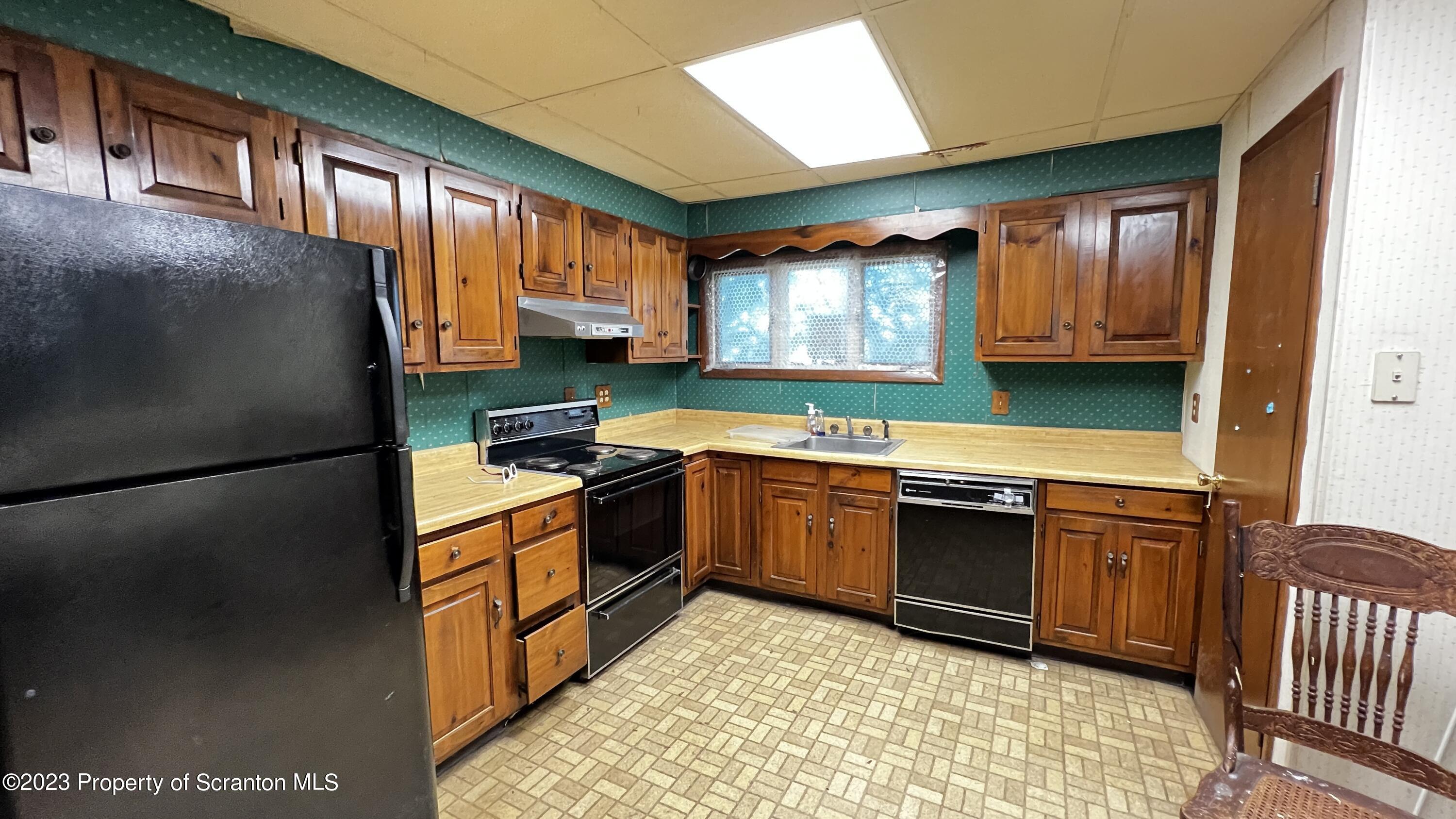 102 Wayne Street Carbondale, PA 18407 - Photo 13 of 21 a kitchen with stainless steel appliances granite countertop a stove a sink and a refrigerator