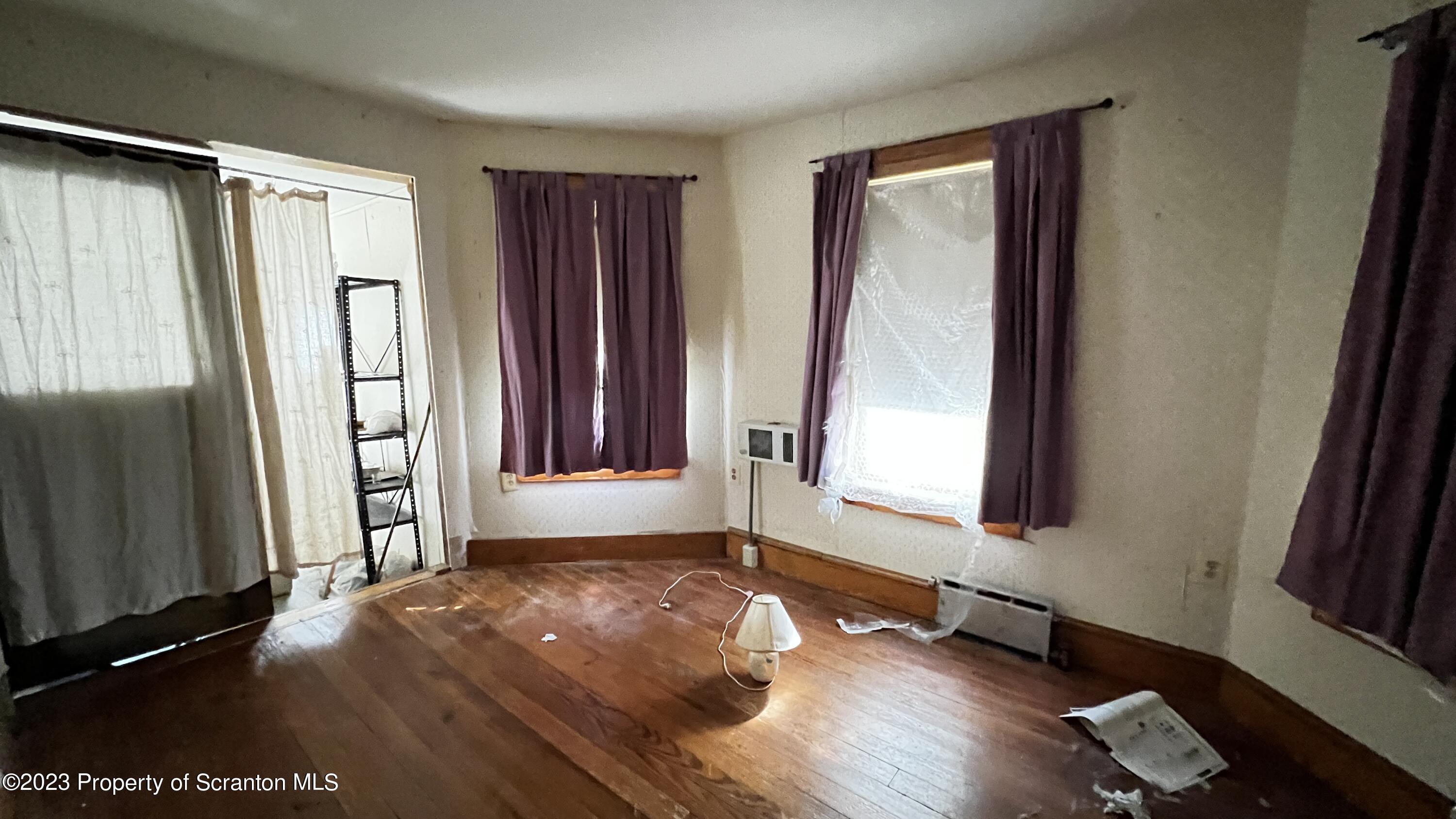 102 Wayne Street Carbondale, PA 18407 - Photo 18 of 21 a view of an empty room with a window and wooden floor