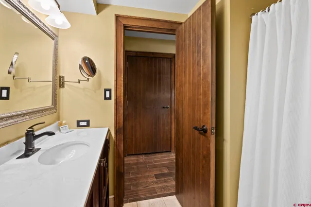 a bathroom with a sink a mirror and a shower