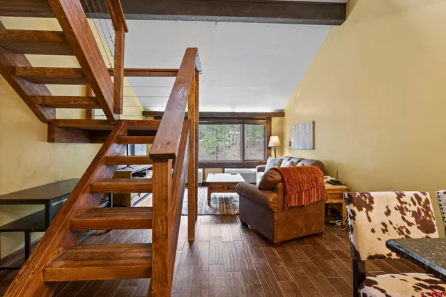a living room with furniture and a floor to ceiling window
