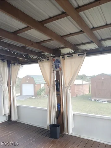 a view of porch with a table and chairs