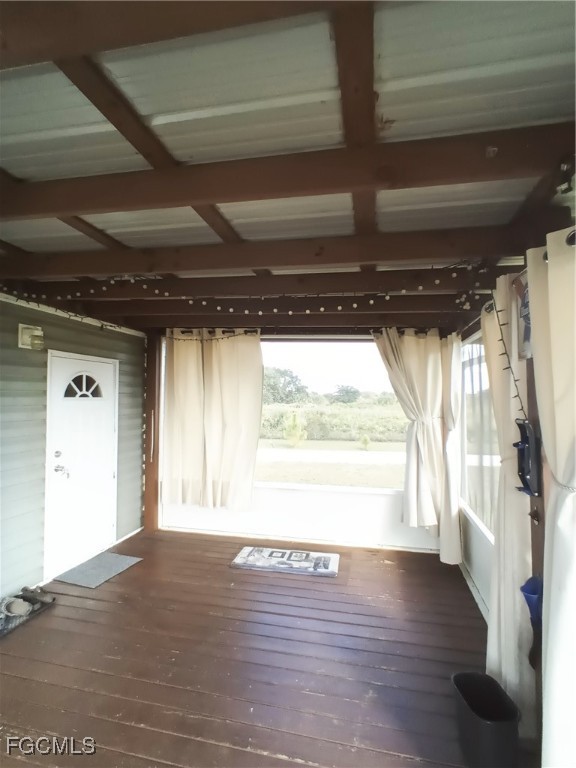 15582 Northwest 316th Street Okeechobee, FL 34972 - Photo 17 of 47 a view of an empty room with wooden floor and a window