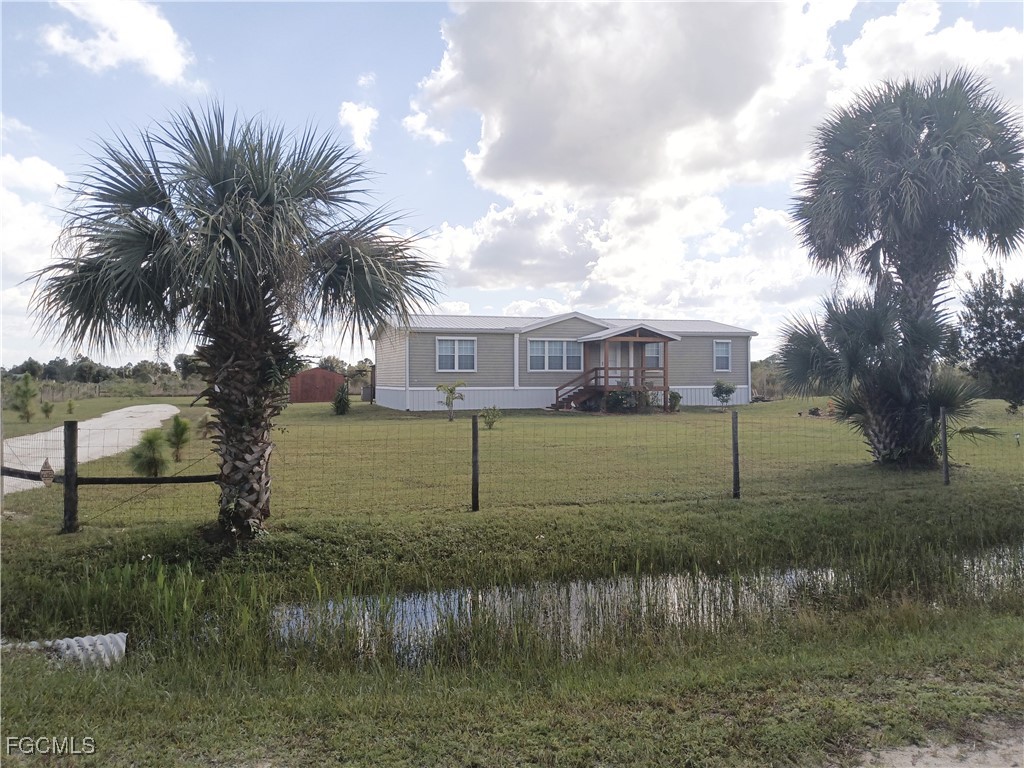 15582 Northwest 316th Street Okeechobee, FL 34972 - Photo 2 of 47 a view of a lake with a house