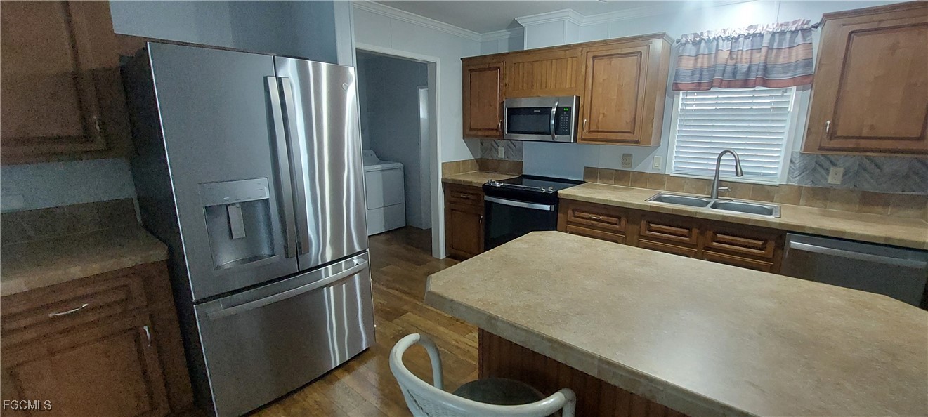15582 Northwest 316th Street Okeechobee, FL 34972 - Photo 22 of 47 a kitchen with a refrigerator stove and sink