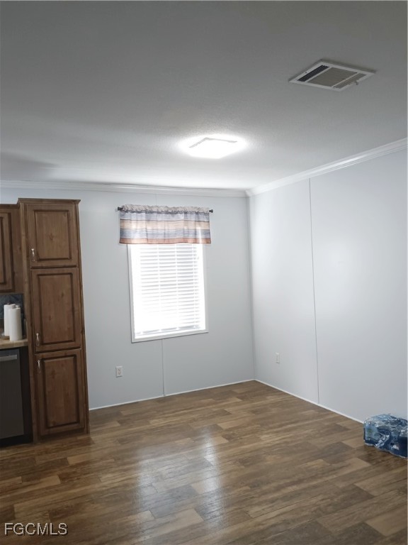 15582 Northwest 316th Street Okeechobee, FL 34972 - Photo 23 of 47 an empty room with wooden floor kitchen view and windows