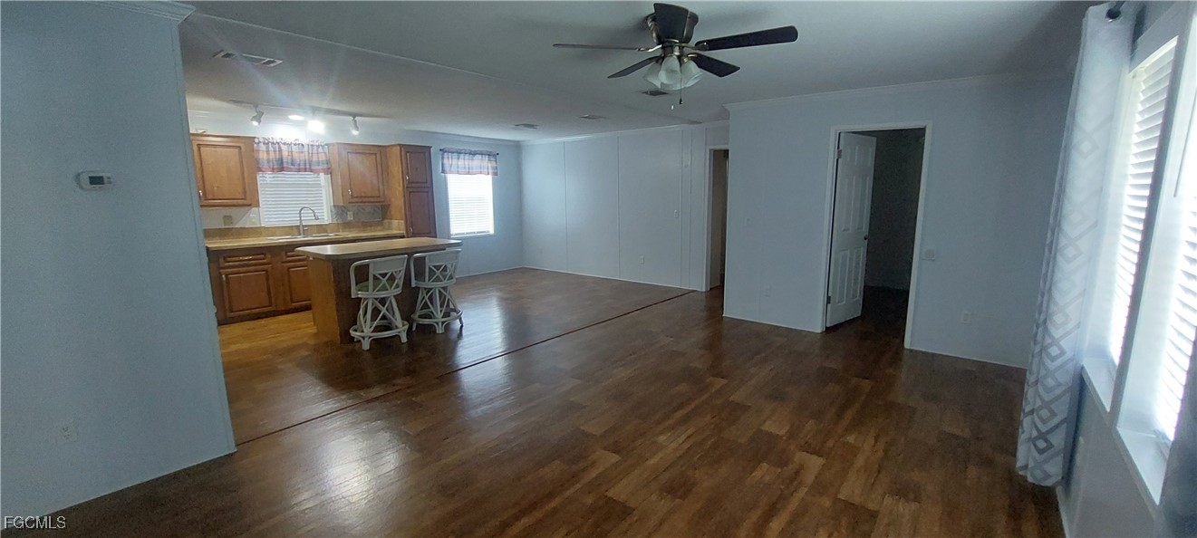 15582 Northwest 316th Street Okeechobee, FL 34972 - Photo 24 of 47 a view of livingroom with hardwood floor and a ceiling fan