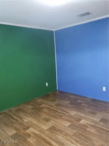 a view of a room with a wooden floor and a window