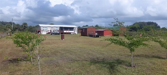 a backyard of a house with table and chairs
