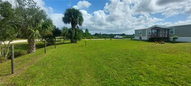 a view of a house with a big yard