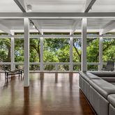 a living room with furniture and a large window with garden view