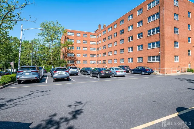 a city street lined with parked cars and buildings