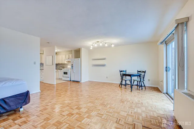 a kitchen with granite countertop a sink stove and cabinets