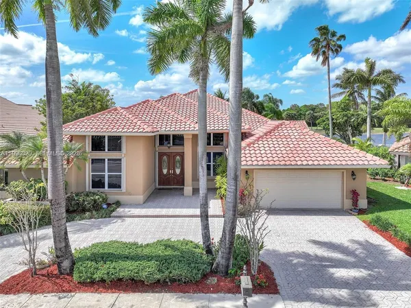 a front view of a house with a garden and patio