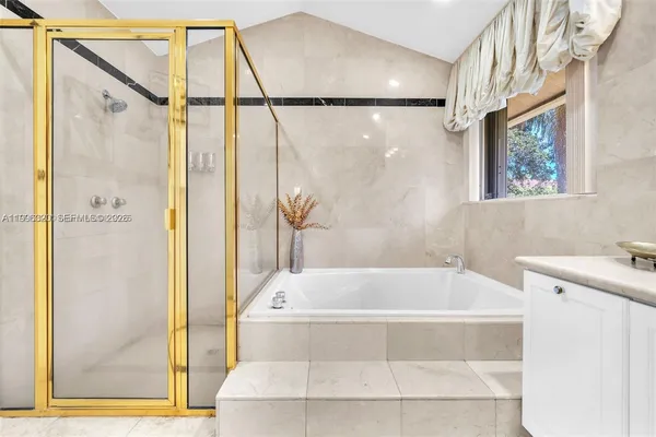 a white bath tub sitting next to a shower