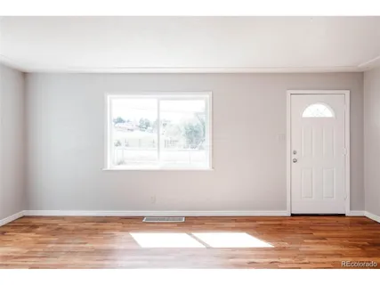 a view of a room with wooden floor and staircase