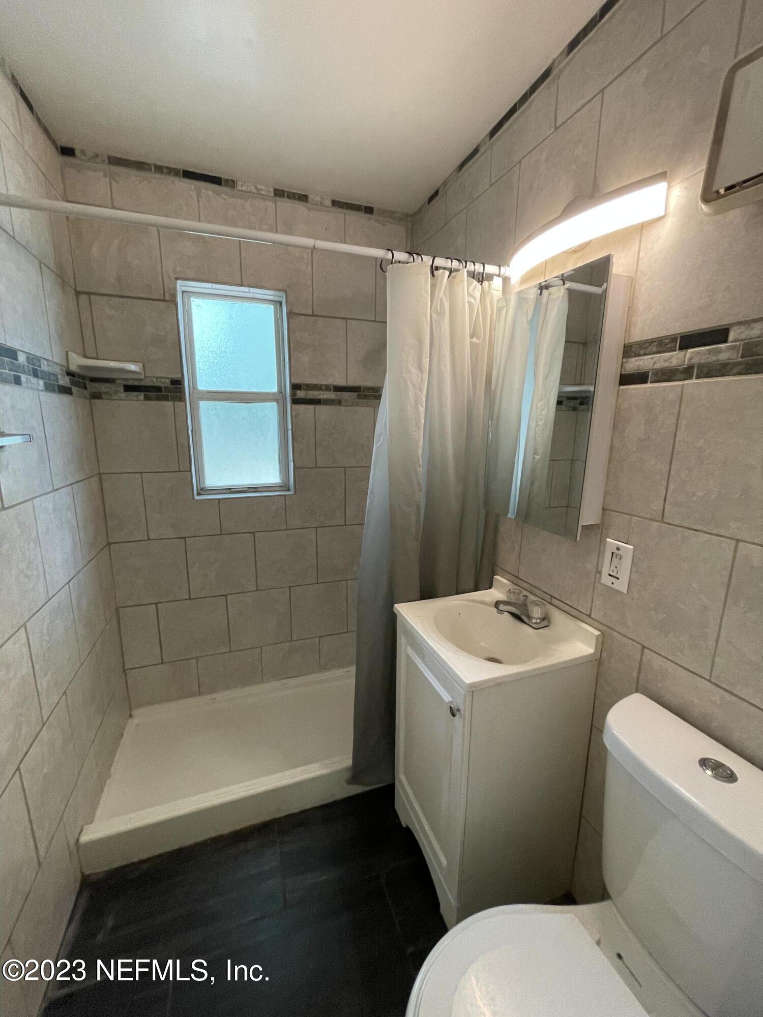 1931 Griflet Road Jacksonville, FL 32211 - Photo 14 of 29 a bathroom with a sink a toilet and shower