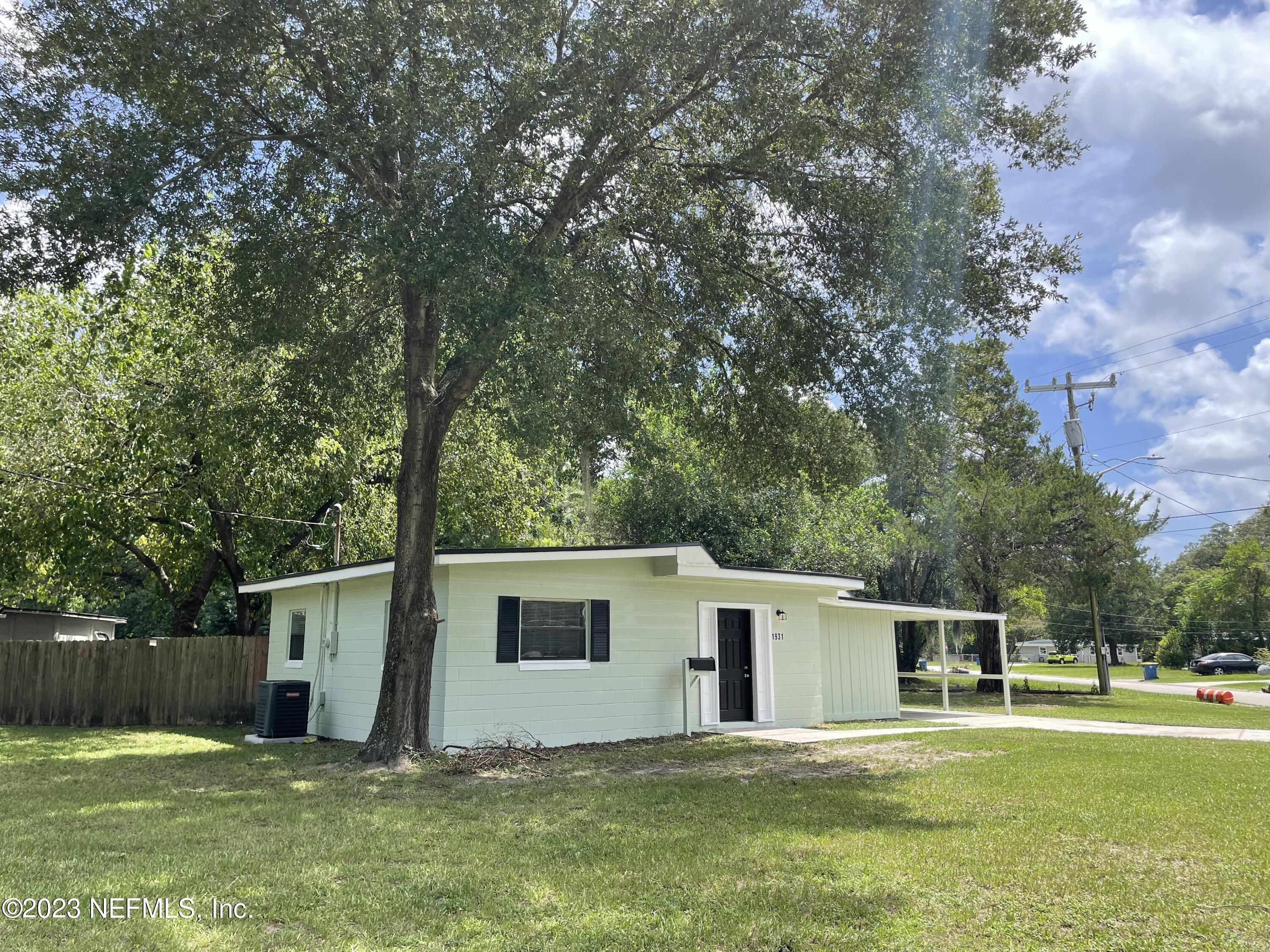 1931 Griflet Road Jacksonville, FL 32211 - Photo 3 of 29 a house with a big yard and large trees