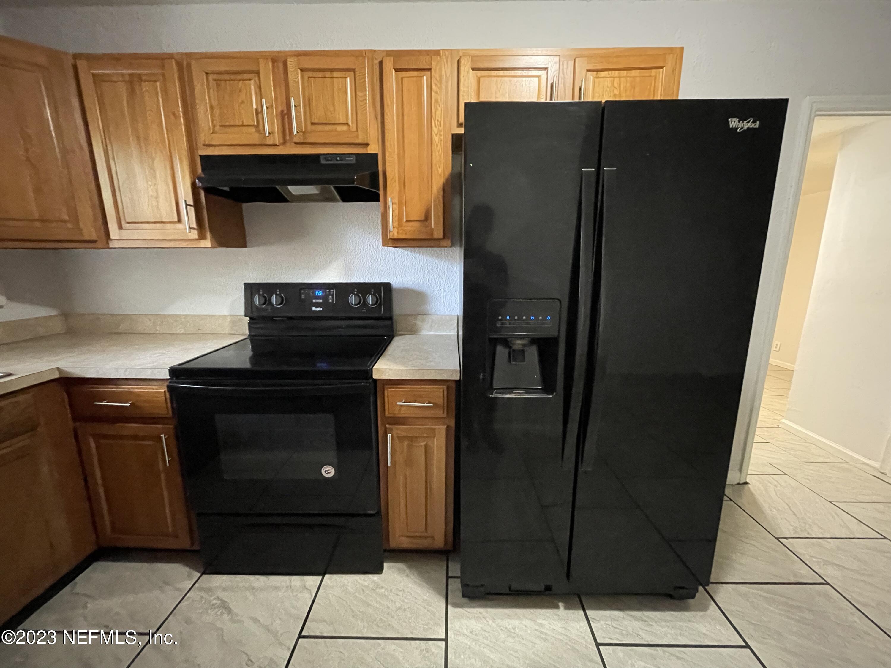 1931 Griflet Road Jacksonville, FL 32211 - Photo 8 of 29 a kitchen with stainless steel appliances granite countertop a refrigerator and a cabinets