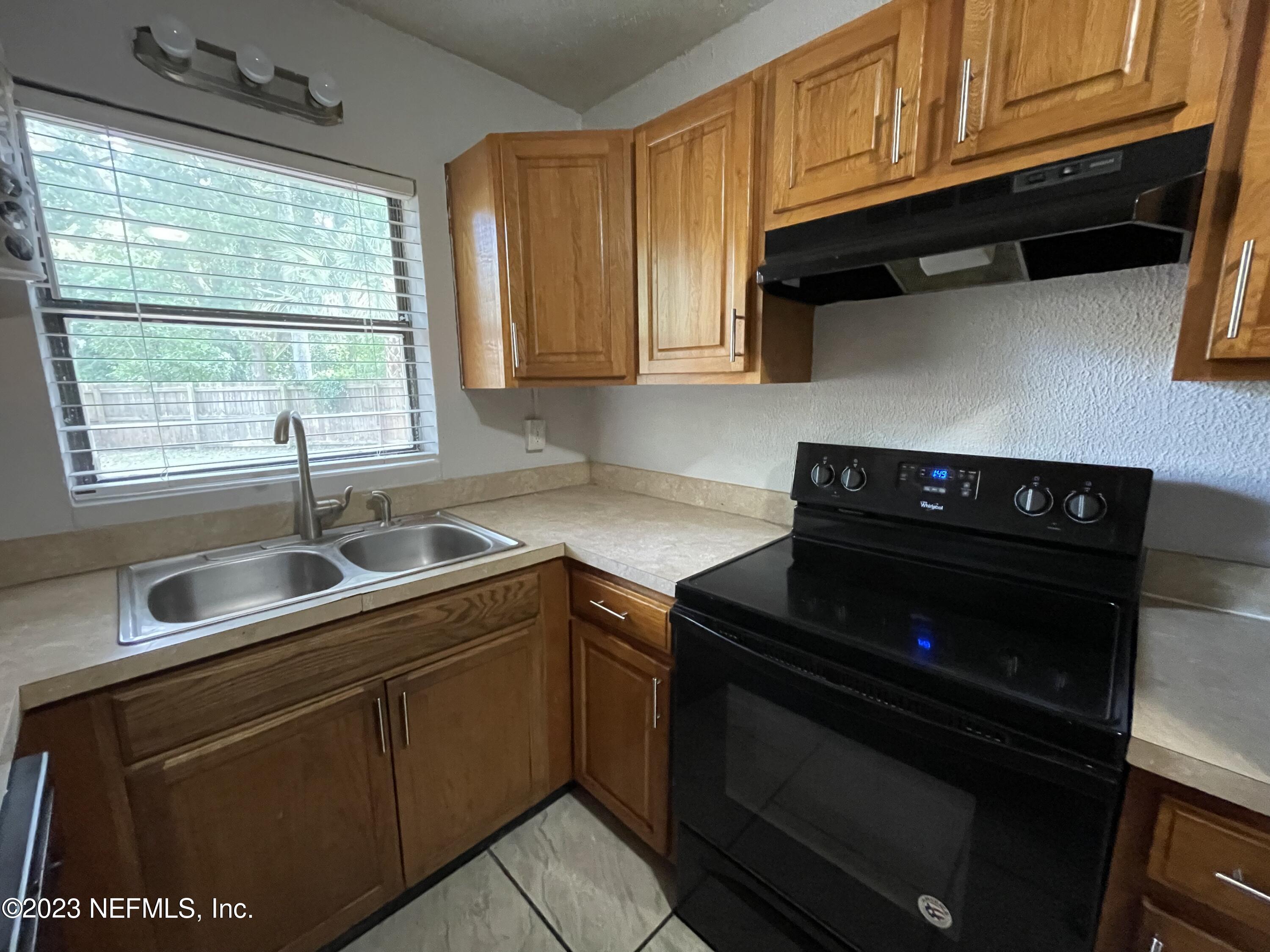 1931 Griflet Road Jacksonville, FL 32211 - Photo 9 of 29 a kitchen with stainless steel appliances granite countertop a sink stove and microwave
