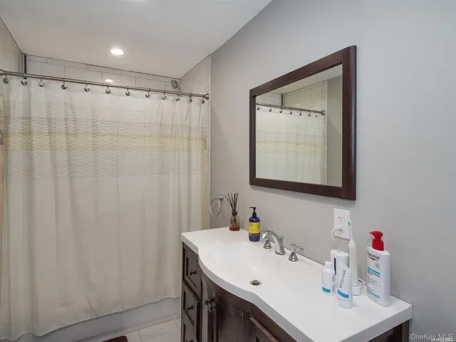 a bathroom with a sink vanity and a mirror