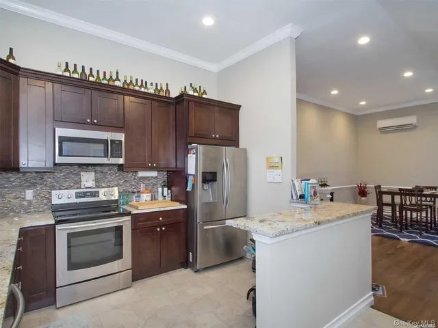 a kitchen with granite countertop a sink stove and refrigerator