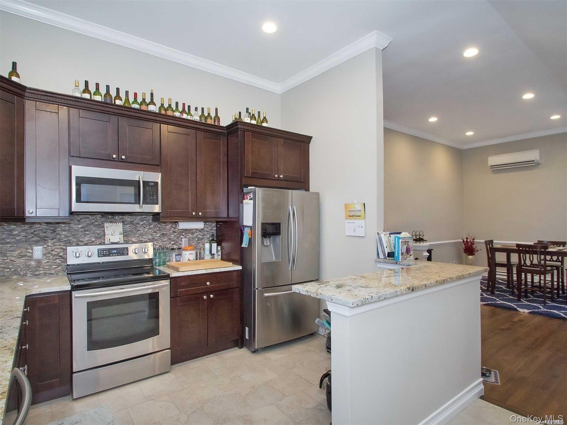 11 Pratt Street West Babylon, NY 11704 - Photo 4 of 15 a kitchen with granite countertop a sink stove and refrigerator