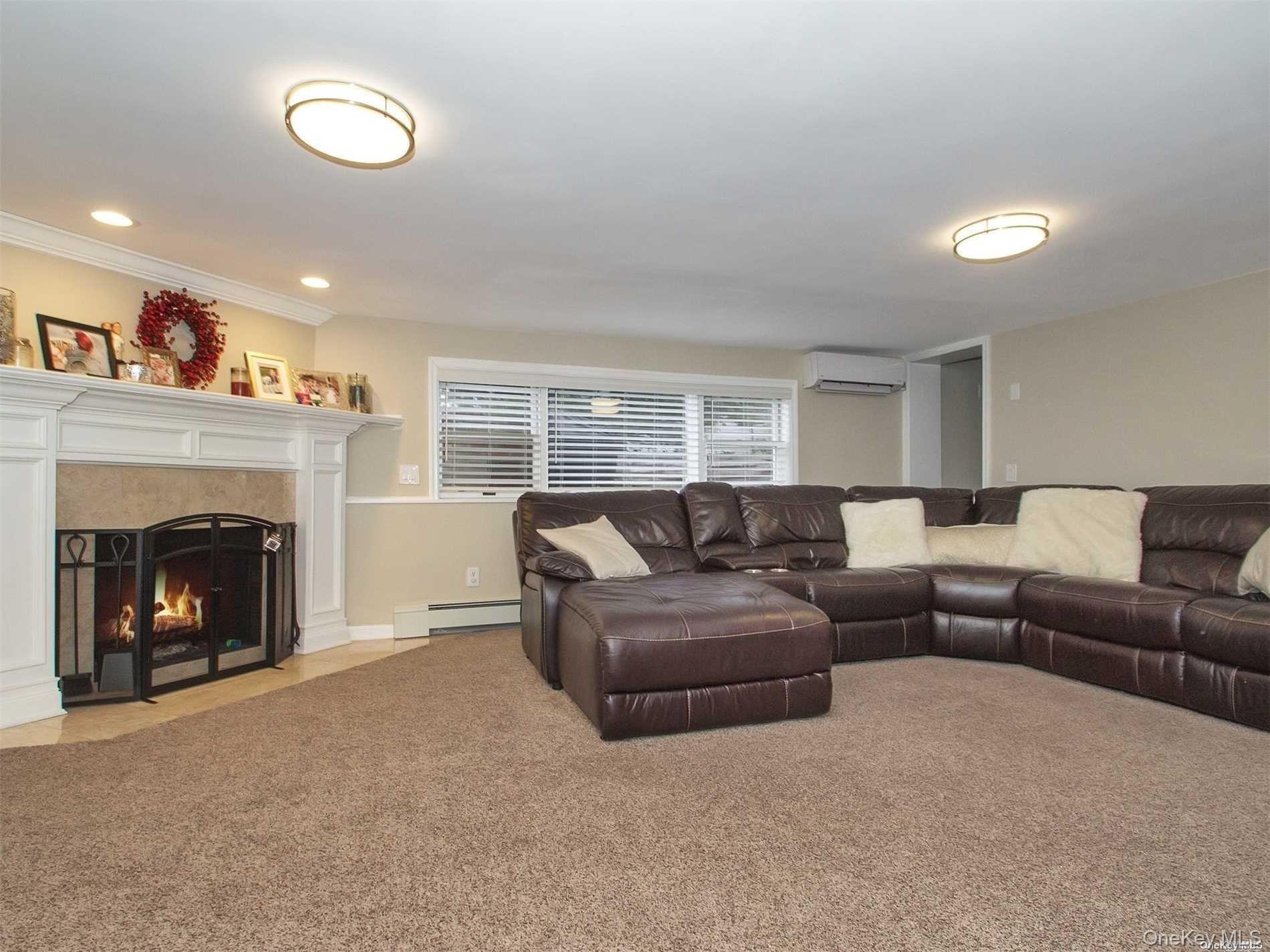 11 Pratt Street West Babylon, NY 11704 - Photo 7 of 15 a living room with furniture and a fireplace