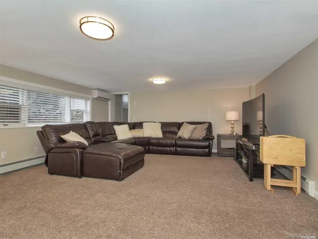 a living room with furniture and a lamp