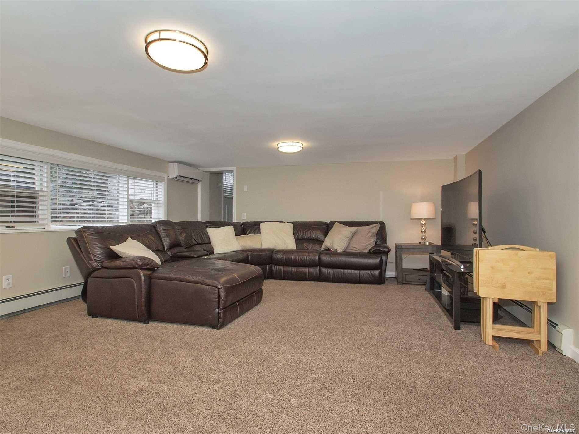 11 Pratt Street West Babylon, NY 11704 - Photo 8 of 15 a living room with furniture and a lamp
