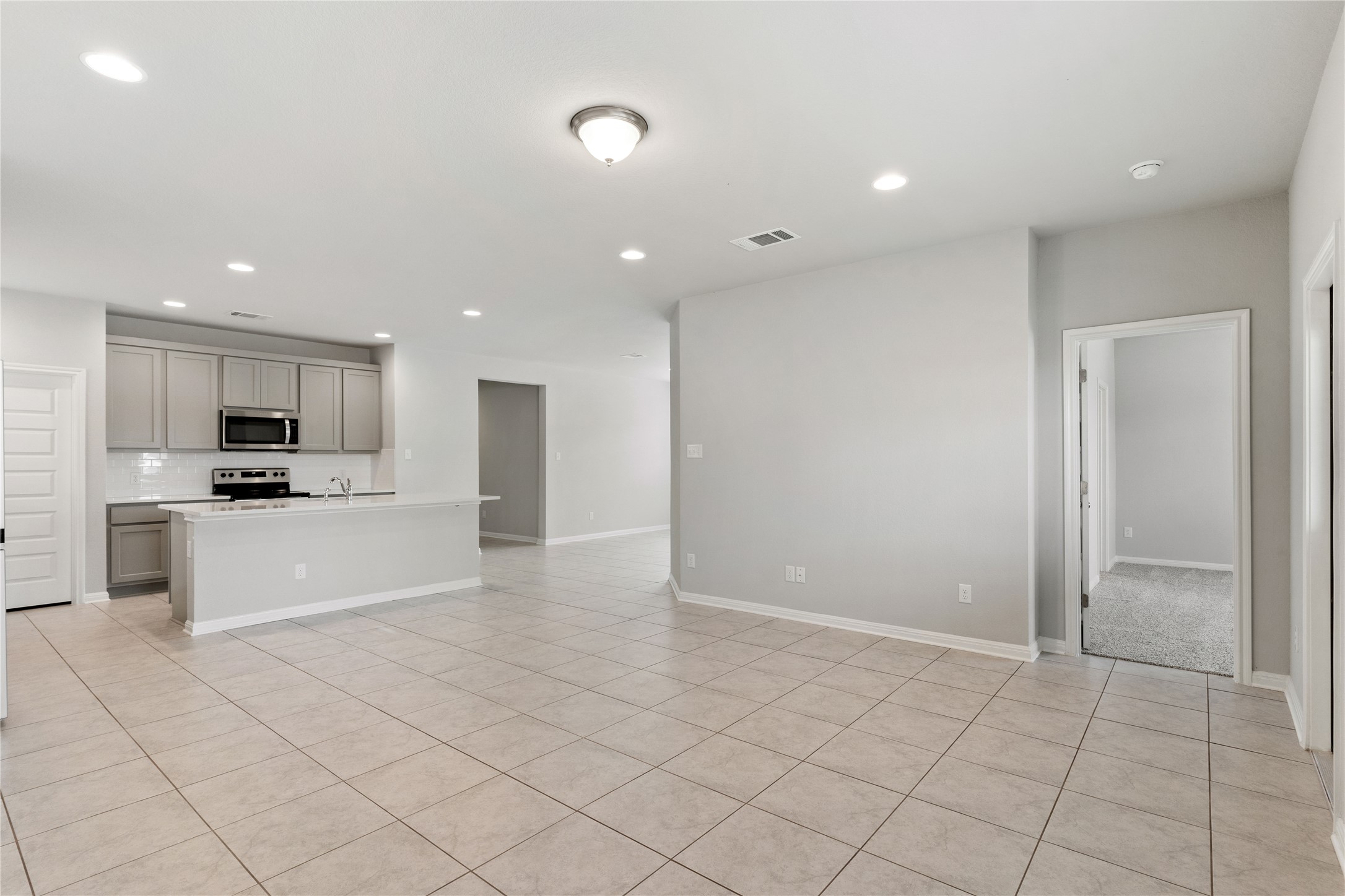 313 Mclintock Road Jarrell, TX 76537 - Photo 12 of 17 A contemporary open-concept layout features a well-appointed kitchen flowing into a spacious living area.