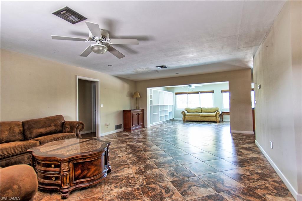 721 Springline Drive Naples, FL 34102 - Photo 5 of 7 a living room with furniture and a chandelier