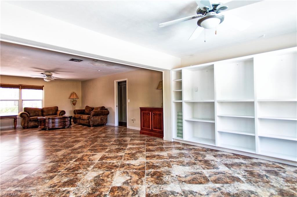 721 Springline Drive Naples, FL 34102 - Photo 6 of 7 a view of a livingroom with furniture and a flat screen tv