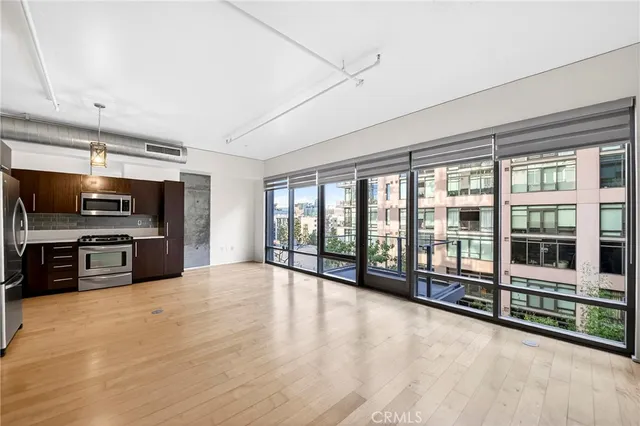 a view of an empty room with kitchen