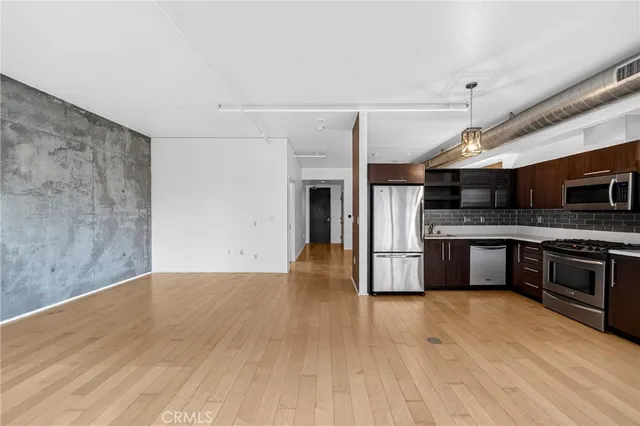 a kitchen with granite countertop a stove and a refrigerator
