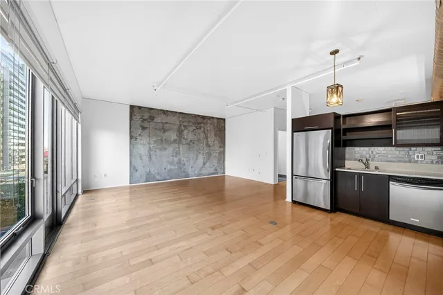 a kitchen with stainless steel appliances granite countertop a stove a refrigerator and a microwave