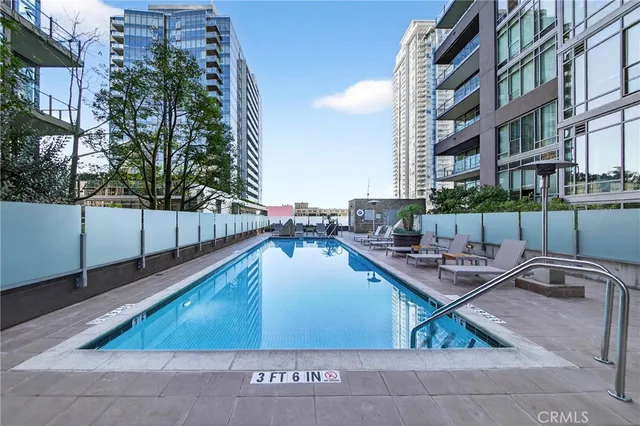 a view of a patio with couches and table and chairs under an umbrella