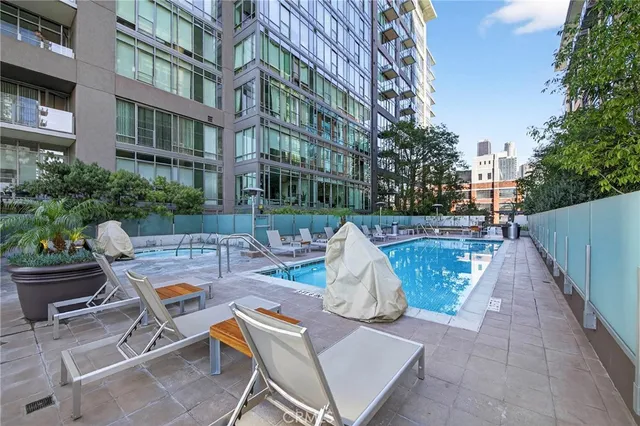 a view of a patio with dining table and chairs under an umbrella