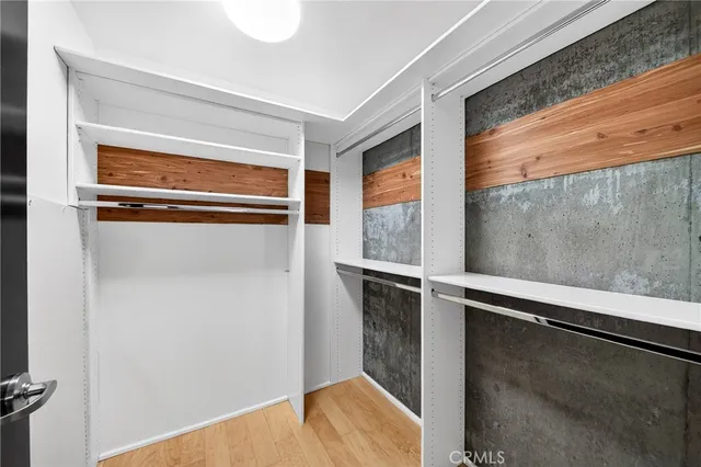 a hallway with sliding door and wooden floor