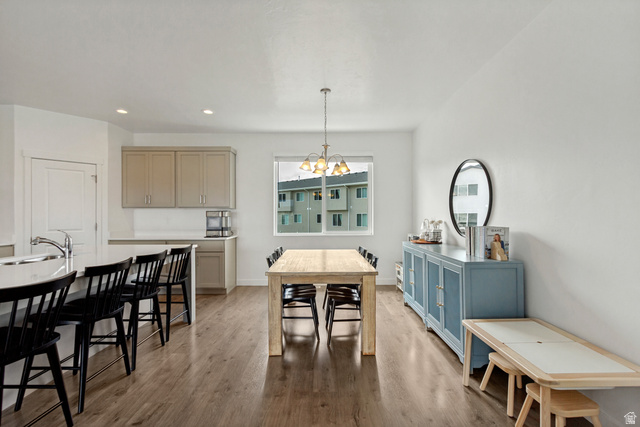 765 Crystal Crk Road American Fork, UT 84003 - Photo 4 of 27 Dining area featuring wood-finish flooring, a contemporary chandelier, and a large window