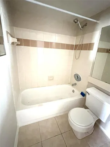 a bathroom with a toilet and a bathtub