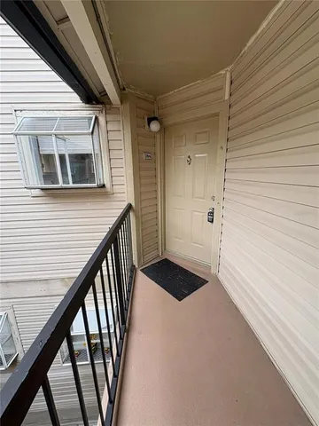 a view of a balcony with wooden floor and stairs