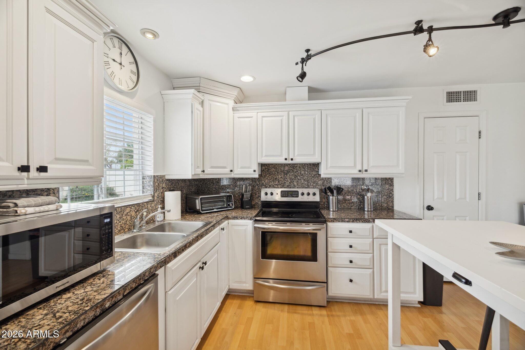 4723 South Country Club Way Tempe, AZ 85282 - Photo 12 of 46 a kitchen with a sink stove and cabinets