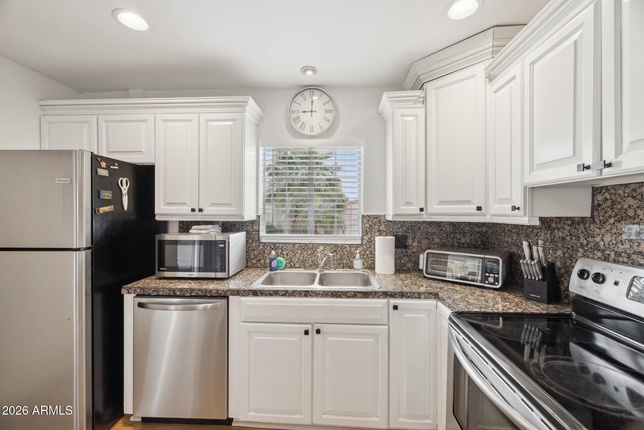 4723 South Country Club Way Tempe, AZ 85282 - Photo 13 of 46 a kitchen with refrigerator a stove a sink and cabinets