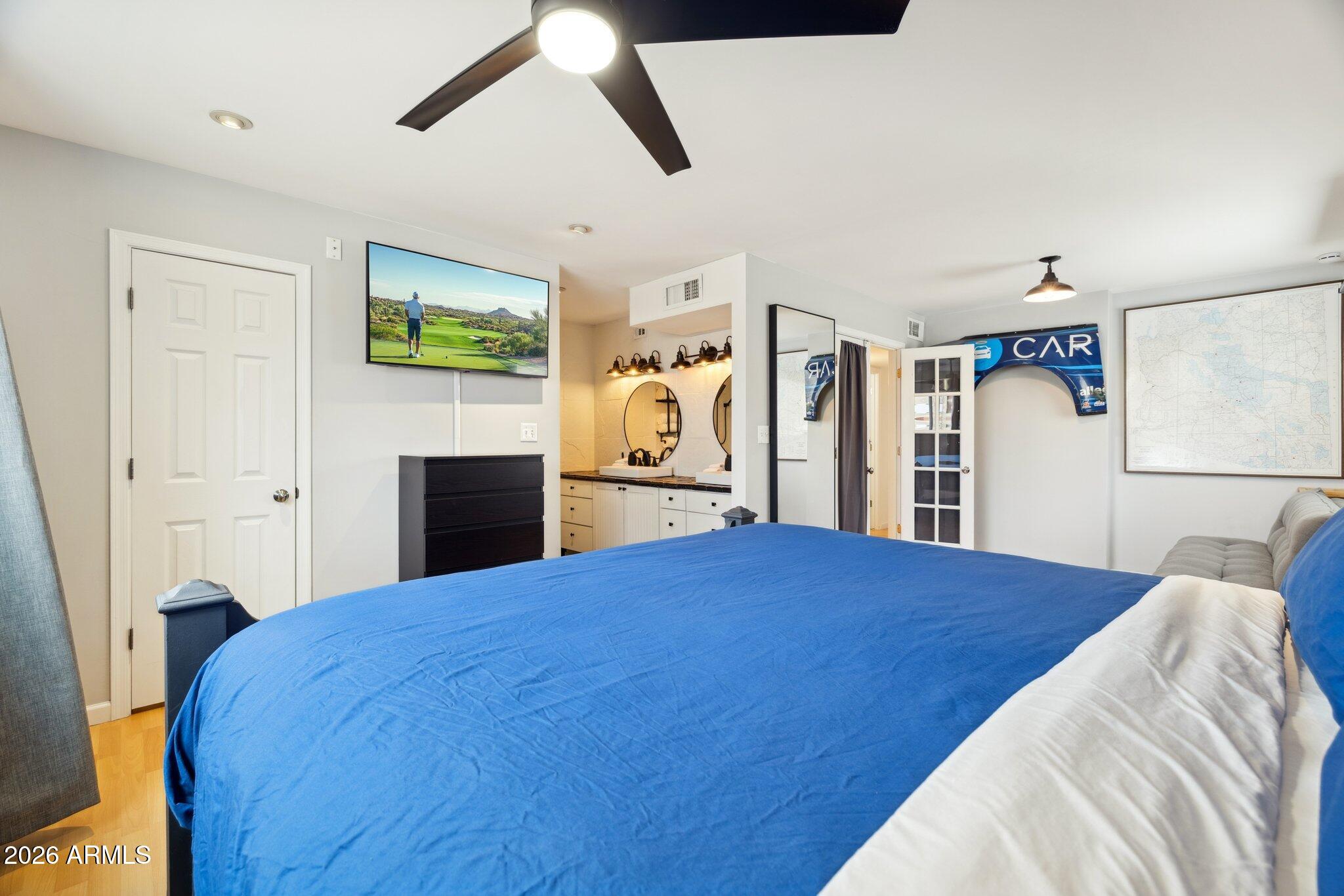 4723 South Country Club Way Tempe, AZ 85282 - Photo 19 of 46 a bedroom with a large bed and a tv