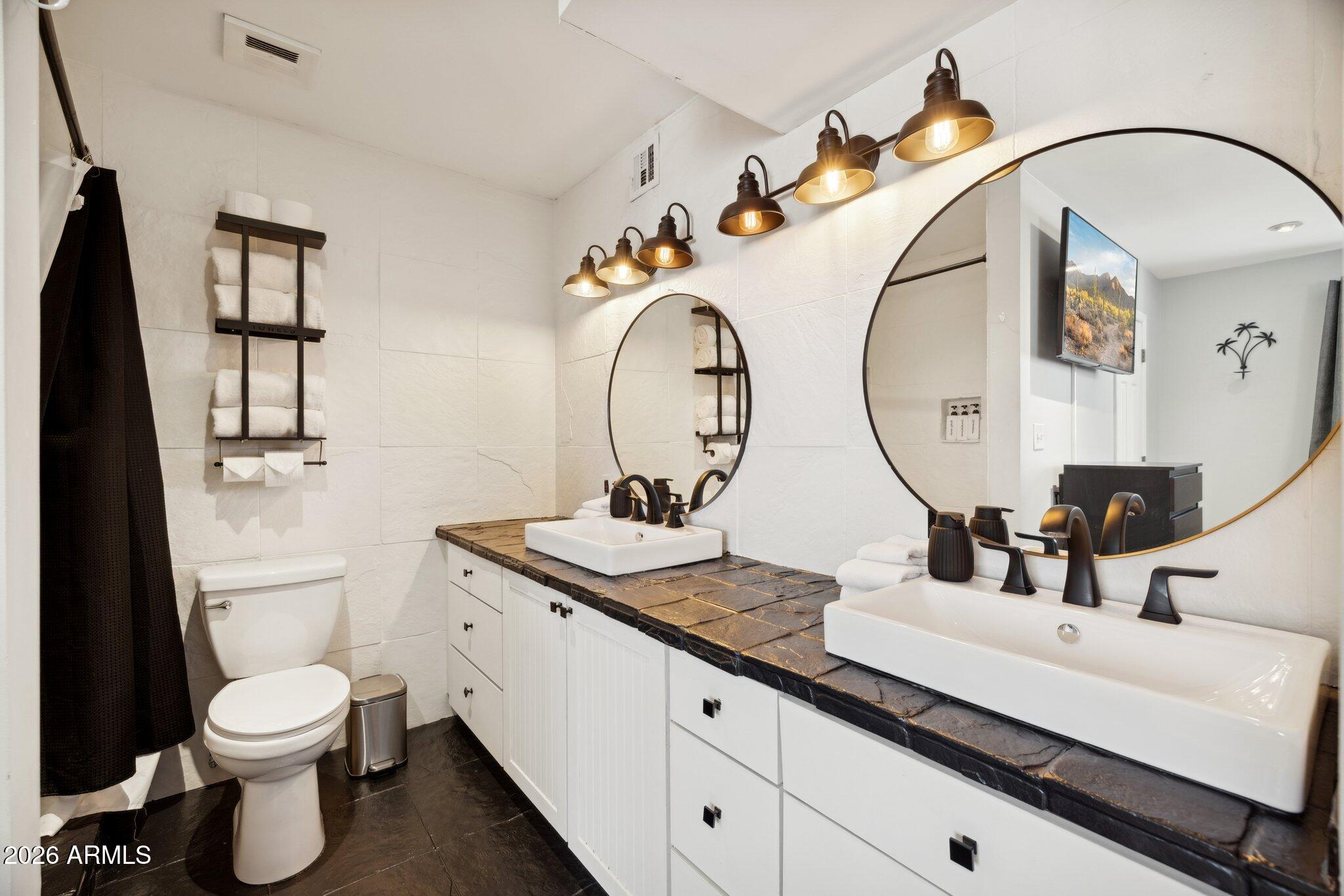 4723 South Country Club Way Tempe, AZ 85282 - Photo 20 of 46 a bathroom with a toilet a sink and a mirror