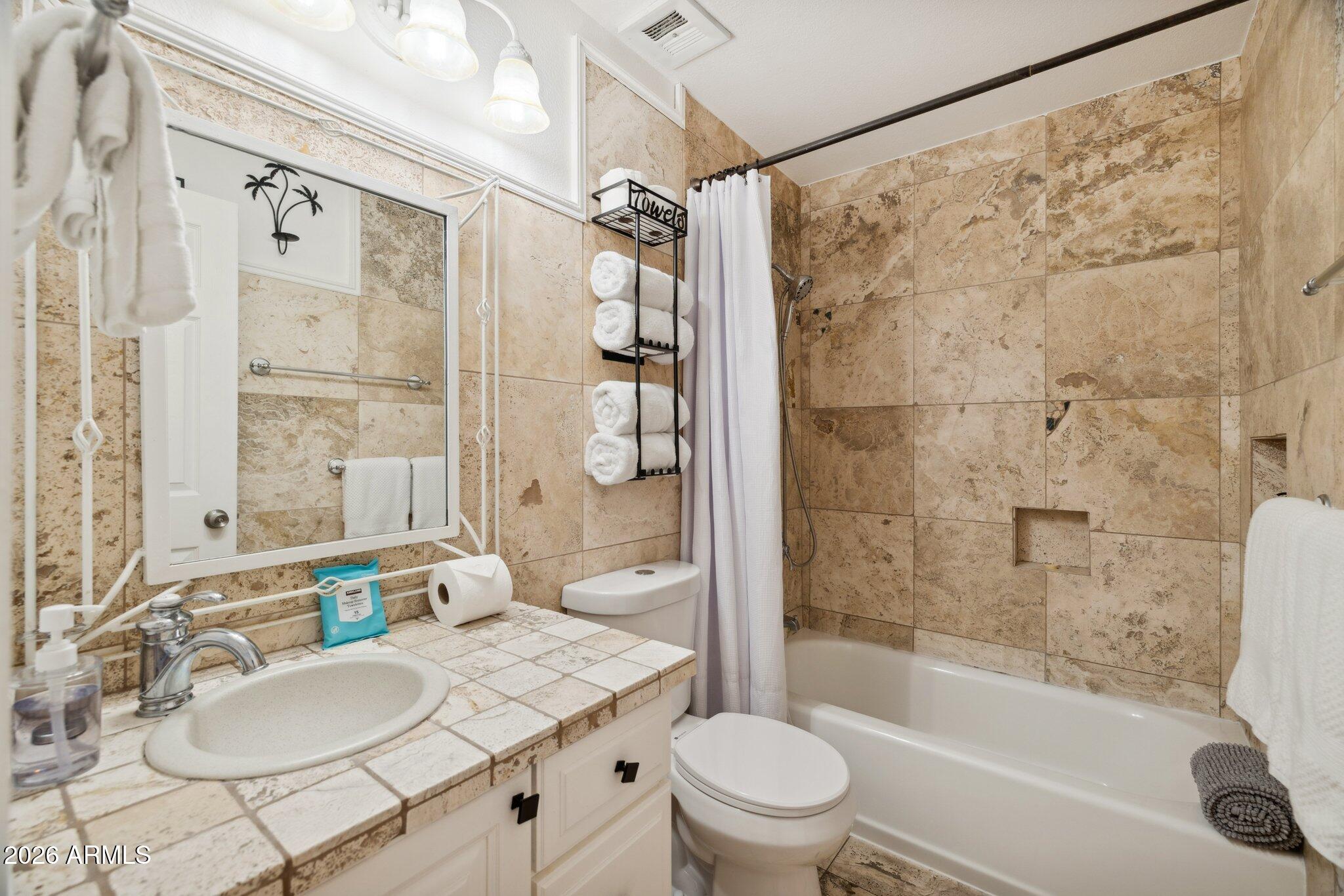 4723 South Country Club Way Tempe, AZ 85282 - Photo 24 of 46 a bathroom with a granite countertop sink mirror toilet and bathtub