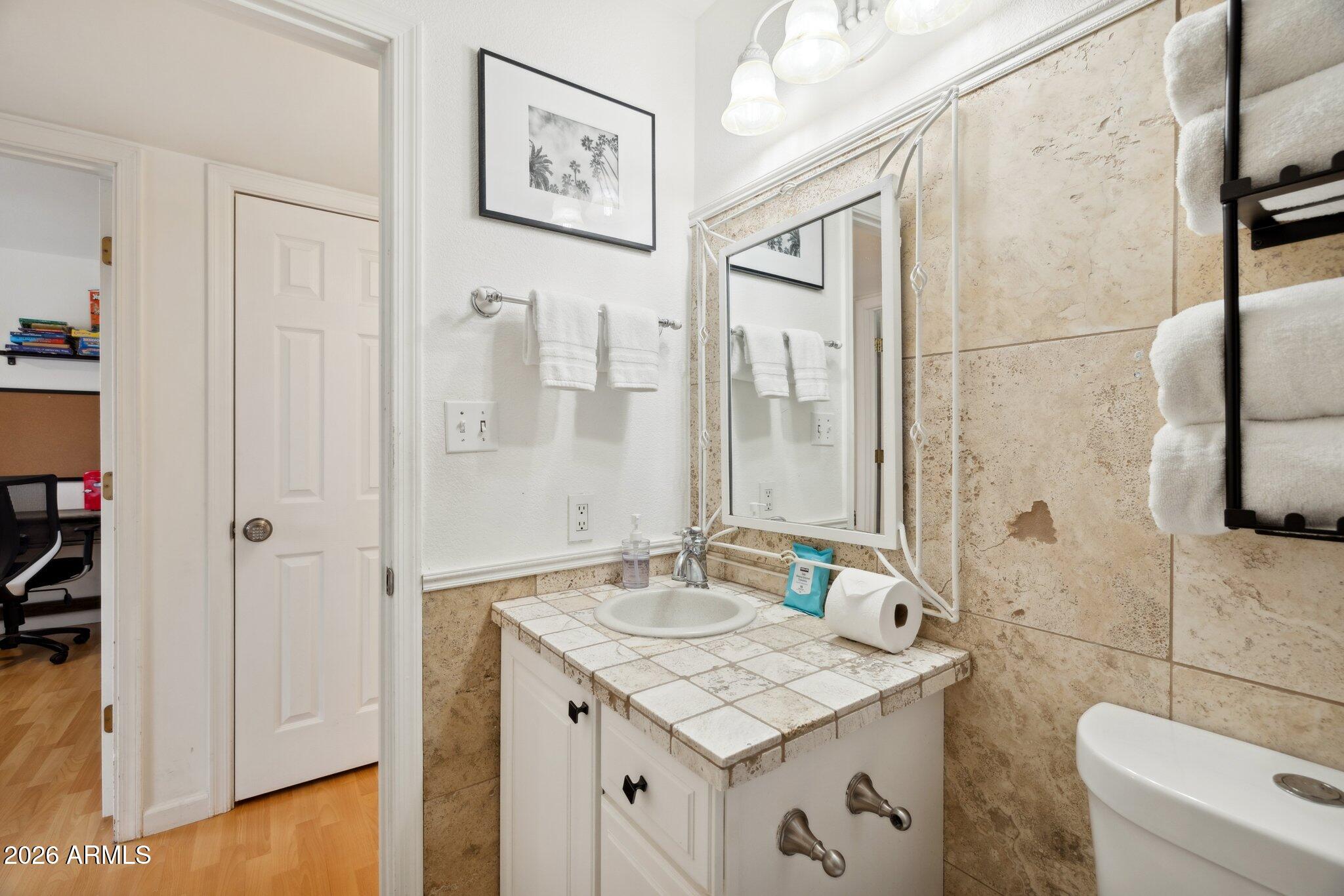 4723 South Country Club Way Tempe, AZ 85282 - Photo 25 of 46 a bathroom with a granite countertop sink a toilet and shower
