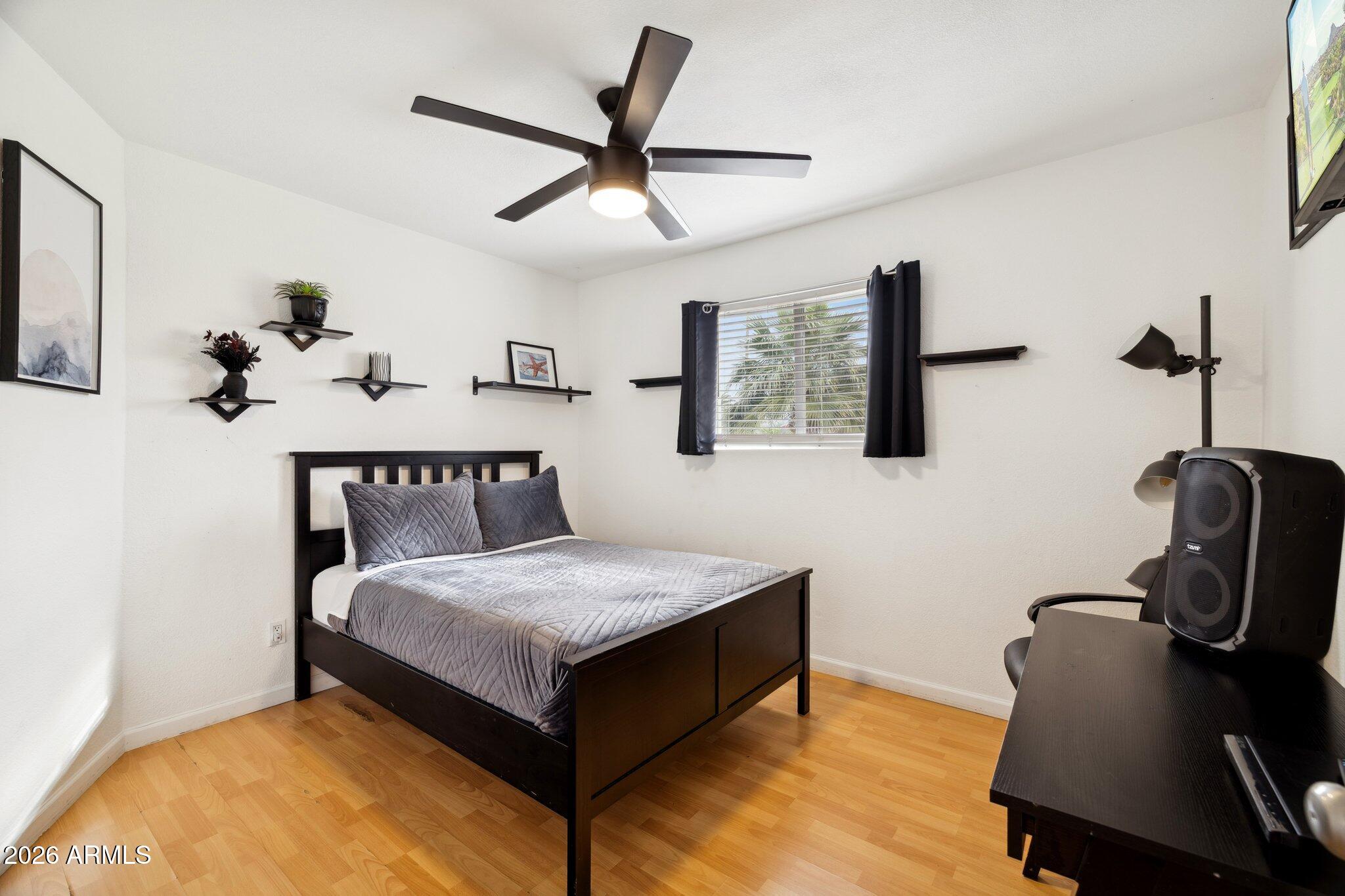 4723 South Country Club Way Tempe, AZ 85282 - Photo 26 of 46 a bedroom with a bed and a chandelier