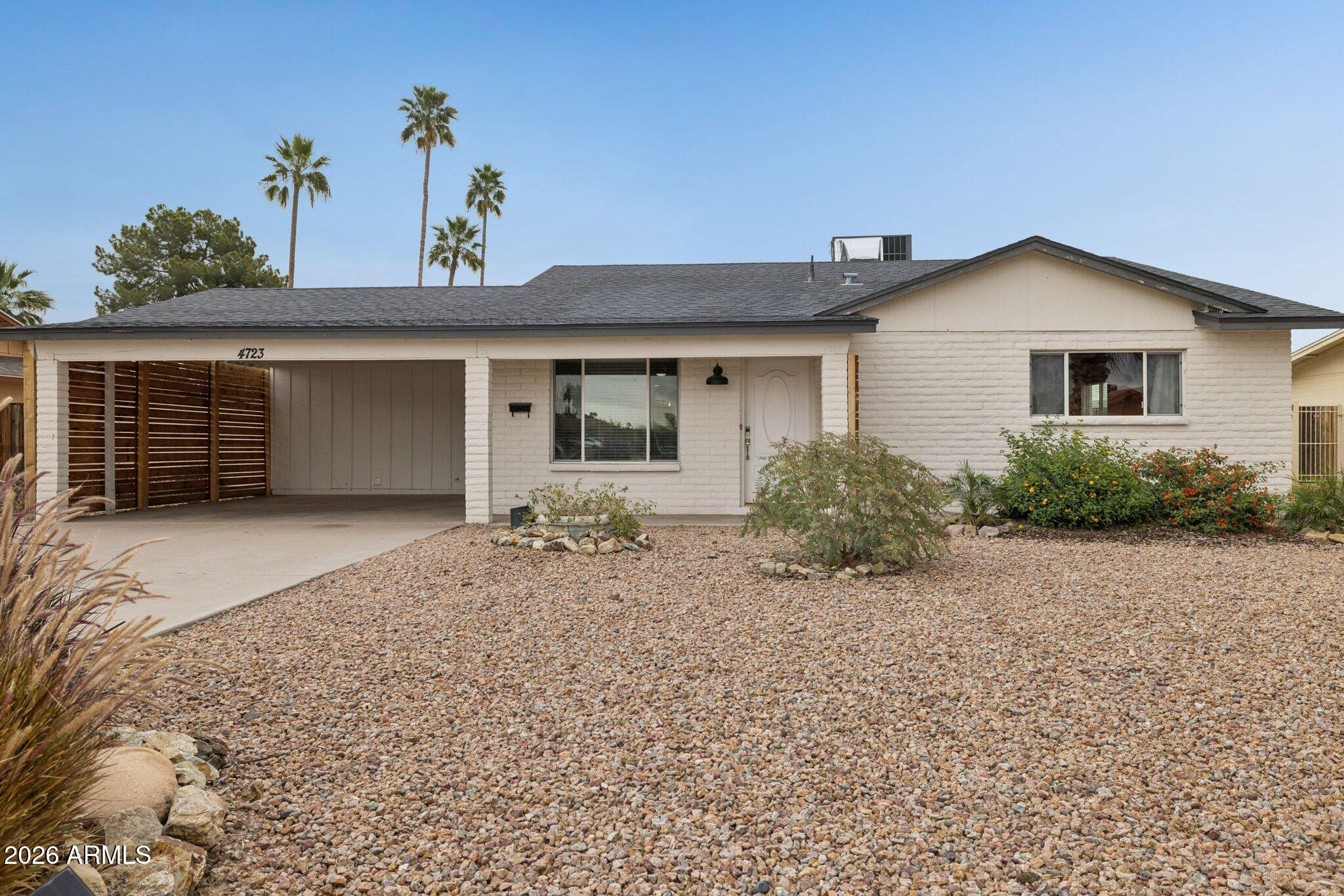 4723 South Country Club Way Tempe, AZ 85282 - Photo 2 of 46 a front view of a house with a yard and garage