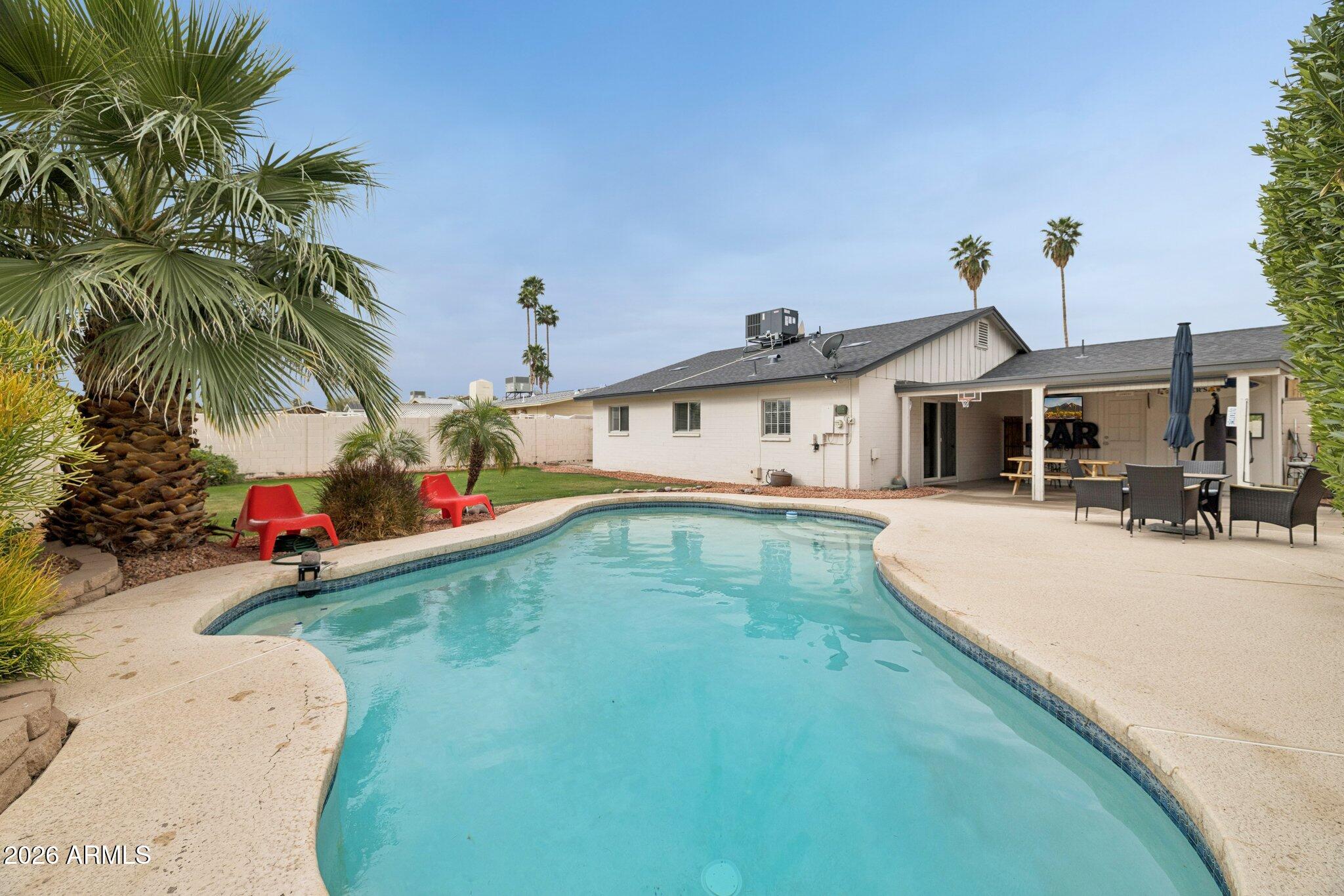 4723 South Country Club Way Tempe, AZ 85282 - Photo 30 of 46 a swimming pool with yard and outdoor seating